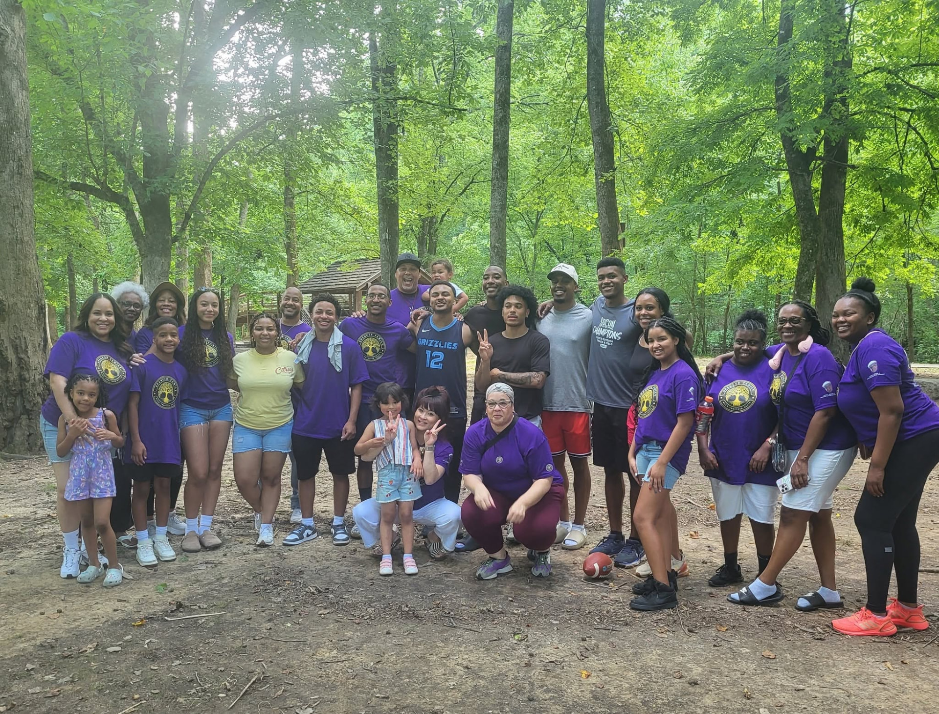 Spencer family group photo in purple reunion shirts at the park