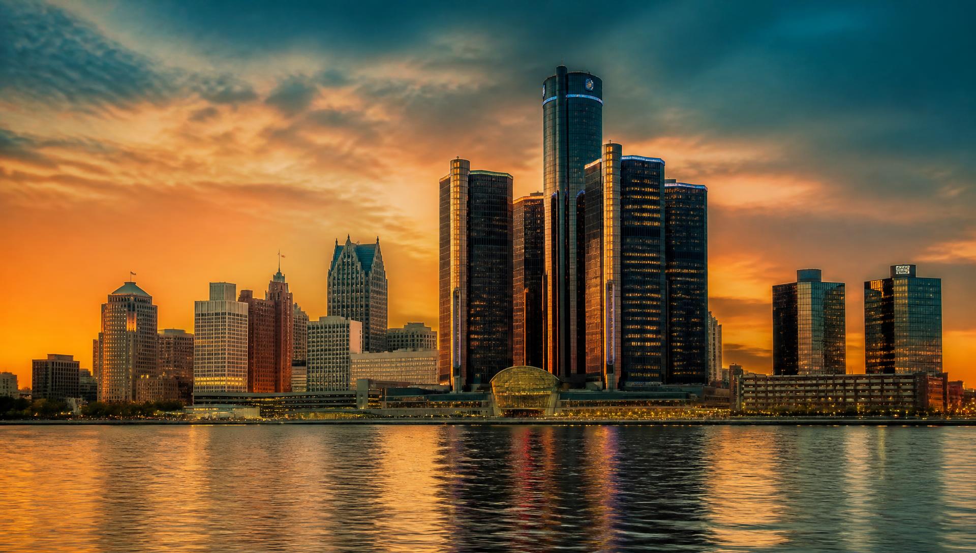 Detroit skyline at sunset with the Renaissance Center towers reflected in the Detroit River